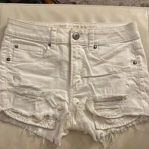 Distressed white denim shorts